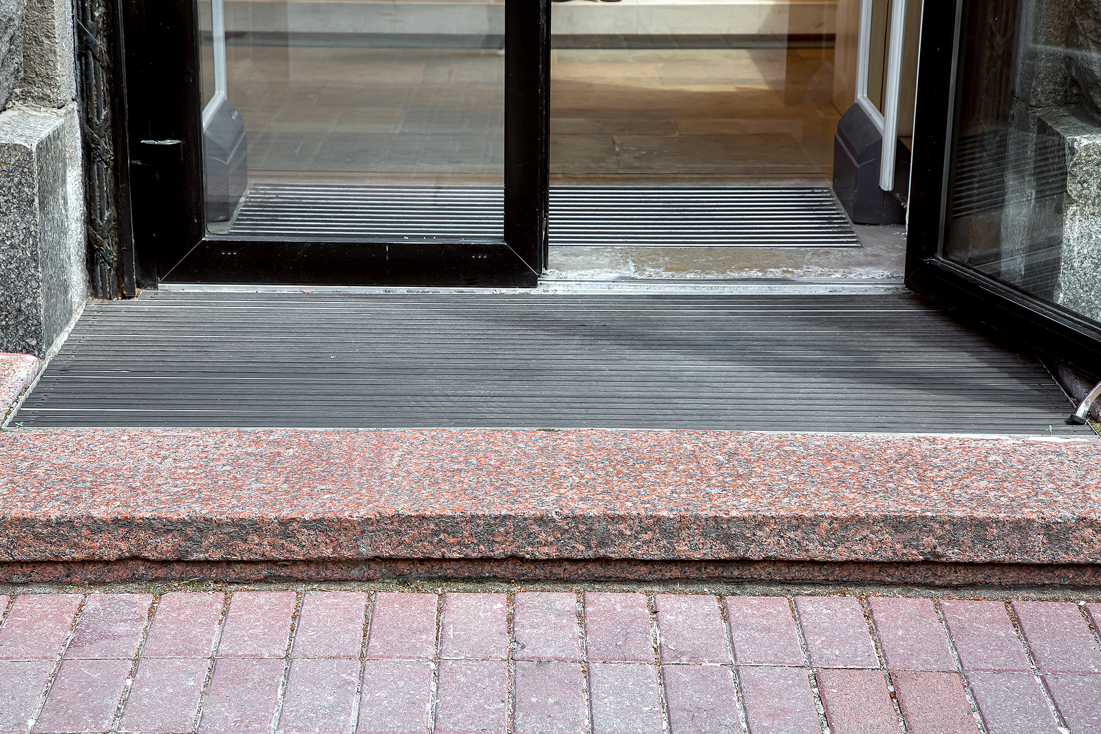 heavy-duty commercial entrance mats - entrance with granite threshold to store