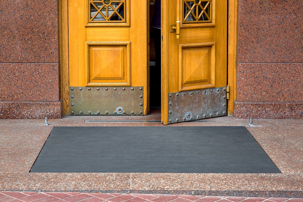 specialist mats - black rubber foot mat at opening yellow door