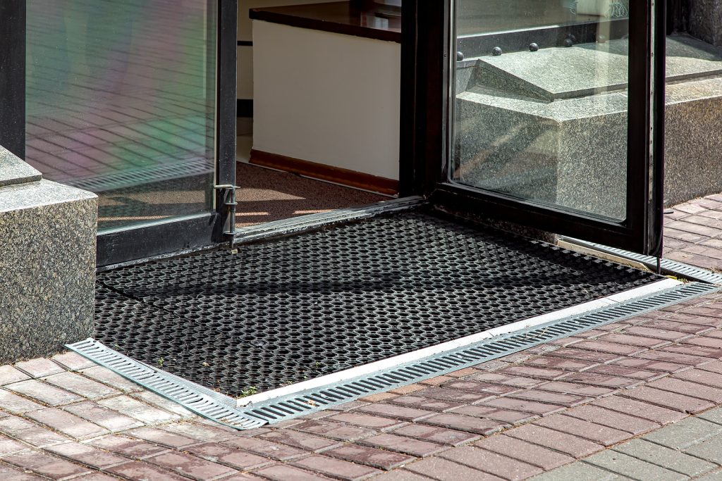 heavy duty rubber floor matting - entrance to store from pedestrian sidewalk with rubber foot mat