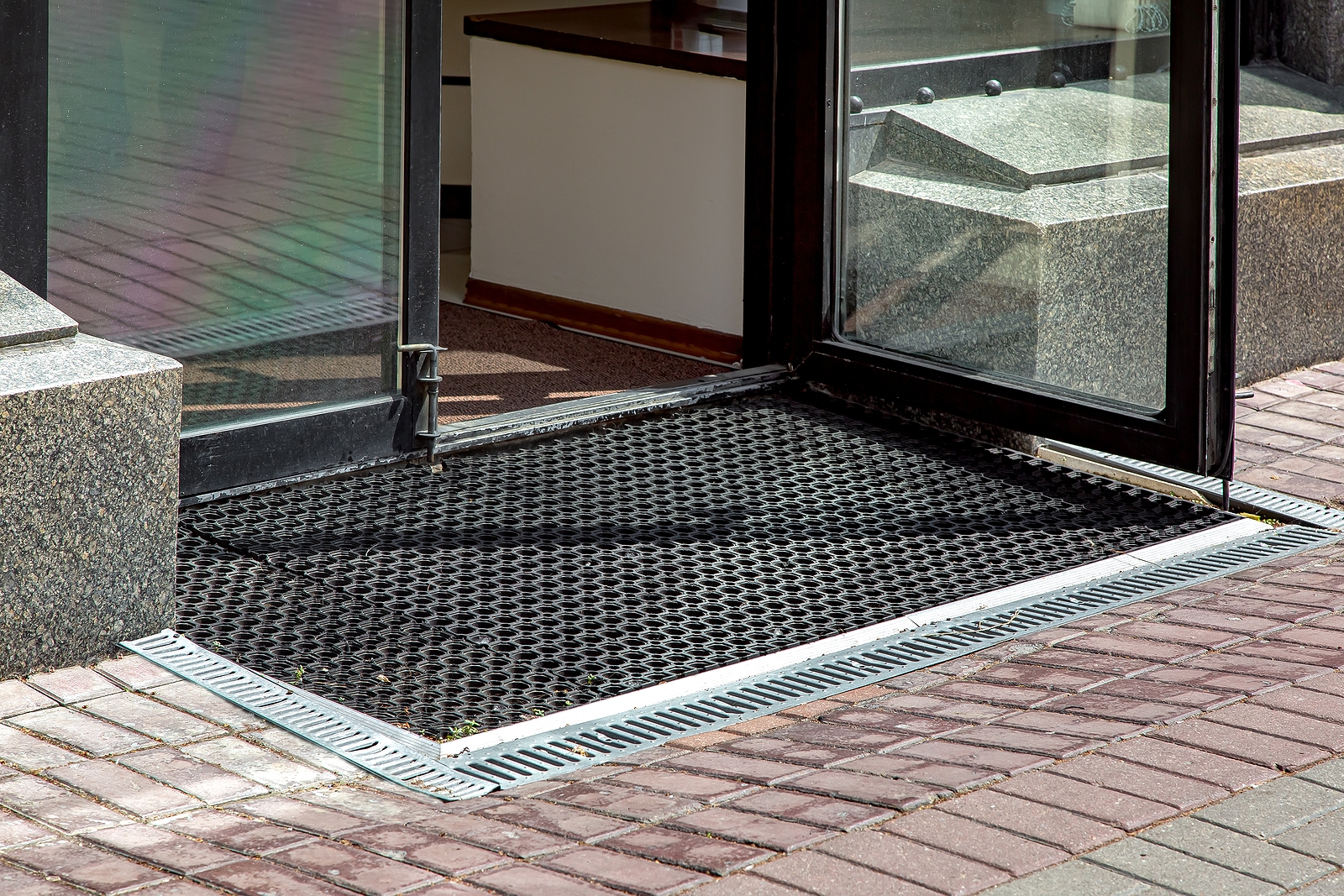 heavy duty rubber floor matting - entrance to store from pedestrian sidewalk with rubber foot mat
